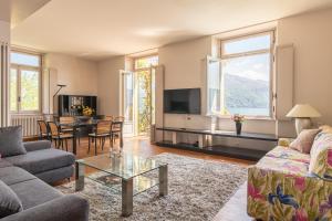 a living room with a couch and a table at Apartment Yoko - Griante in Griante Cadenabbia