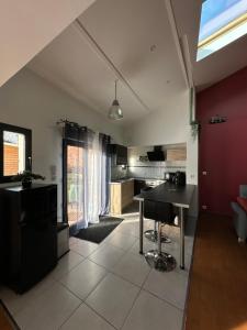 uma cozinha e sala de estar com uma mesa em Le cocoon em Forges-les-Eaux