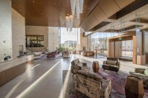 a lobby with couches and chairs in a building at Legacy Resort Hotel & Spa in San Diego