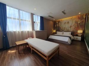 a bedroom with two beds and a large window at Legend Hotel and Resort in Sihanoukville