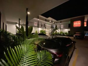 Red Heritage Hotel في Ban Mon: سيارة سوداء متوقفة في موقف للسيارات