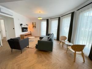 a living room with couches and tables and windows at OlivAparts in Mugla