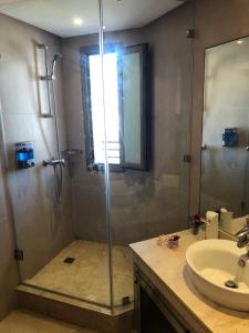 a bathroom with a shower and a sink at Luxury Apprt 2 ch ,prestigia des nations in Sidi Bouqnadel