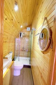 uma casa de banho com um chuveiro, um WC e um lavatório. em Ruby Homestay Cần Giờ 