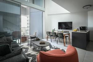 a living room with a couch and a table at Luxury 3BR Duplex with Sea View in Tel-Aviv Center by Sea N' Rent in Tel Aviv