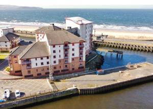 an aerial view of a building next to the ocean at Anchors Away in Ayr