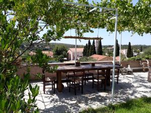 a table and chairs under a pergola on a patio at Casa Muraglia Studio/Studio Under Castle in Travliáta