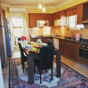 a kitchen with a dining room table and chairs at Villa Latanya in Dalaman