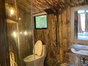 a bathroom with a toilet and a sink at The Moonlight Villa in Sóc Sơn +61 photos
