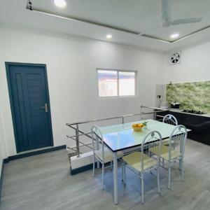 a kitchen and dining room with a table and chairs at Noya Inn in Fuvahmulah