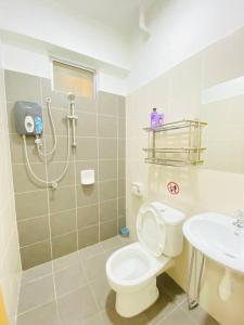 a bathroom with a toilet and a sink at Cozy 3BR Apartment with Free Netflix in Bayan Lepas