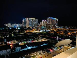 a view of a city at night with tall buildings at Cozy 3BR Apartment with Free Netflix in Bayan Lepas