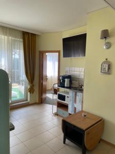 a living room with a table and a kitchen at Hotel Trakata in Varna City
