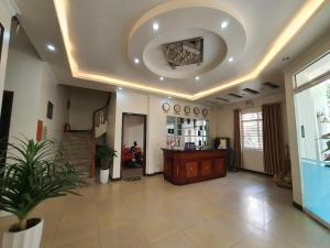 a large room with a ceiling with a room with a table at Star Hotel Hai Duong in Hải Dương