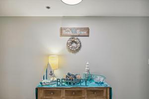 a table with a happy birthday sign on a wall at Destin Towers Condo 61 Condo in Destin