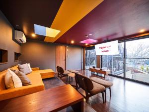 a room with a couch and a table and a screen at Rakuten STAY x EAGLES 202 with Roof balcony in Sendai