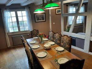a dining room with a wooden table and chairs at Dock 23 in Colmar