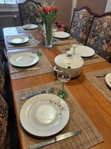 a wooden table with plates and wine glasses on it at Dock 23 in Colmar