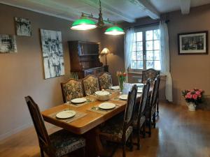 a dining room with a wooden table and chairs at Dock 23 in Colmar