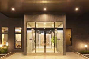 an entrance to a building with a glass door at Hotel Route Inn Choshi Eki Nishi in Choshi