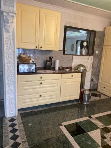 a kitchen with white cabinets and a mirror at Villa in Walsrode in Walsrode