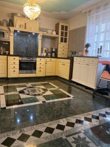 a kitchen with white cabinets and a checkered floor at Villa in Walsrode in Walsrode