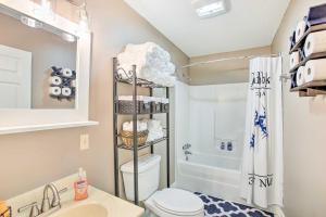 a bathroom with a toilet and a sink and a shower at Welcoming Byrdstown Home Walk to Main St! in Byrdstown