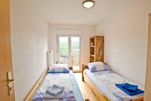 two beds in a room with a window at Gasthof Hirsch in Waldstetten