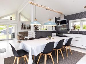 a kitchen and dining room with a white table and chairs at 6 person holiday home in Otterup in Otterup