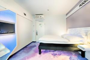 a small room with a bed and a tv at B&B Hotel Bremen-Altstadt in Bremen
