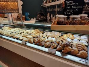 a display case in a bakery with a bunch of donuts at Nelli Rooms Via Veneto in La Spezia
