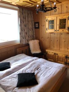 a bedroom with a bed and a window and a chair at Fanny Appartment in Bad Gastein
