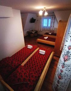 a room with two beds with red sheets in it at Pokoje u Janci i Stasia in Poronin