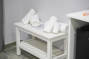 a white table with rolled towels on it at Piedigrotta Magique Luxury in Pizzo +105 photos