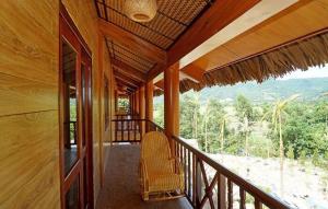 a balcony of a house with a chair on it at Hoa Binh Hotel in Hòa Bình