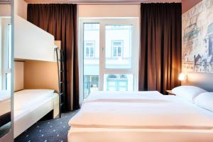 ein Hotelzimmer mit 2 Betten und einem Fenster in der Unterkunft B&B Hotel Eisenach in Eisenach