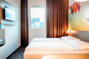 Posteľ alebo postele v izbe v ubytovaní B&B Hotel Cuxhaven