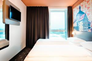 Postel nebo postele na pokoji v ubytování B&B Hotel Bamberg