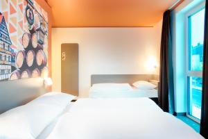 Postel nebo postele na pokoji v ubytování B&B Hotel Bamberg