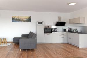 a living room with a couch and a kitchen at Apartments Panoramablick in Mettlach