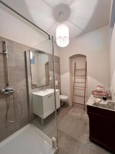 a bathroom with a shower and a sink and a toilet at Maison d'Americains Lapedina in Pietracorbara +62 photos