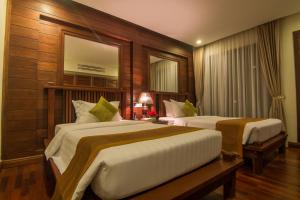 Letto o letti in una camera di Palace Residence & Villa Siem Reap