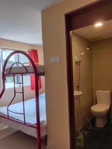 a bathroom with a bunk bed with a toilet and a sink at RAS Hotel in Kuala Lumpur