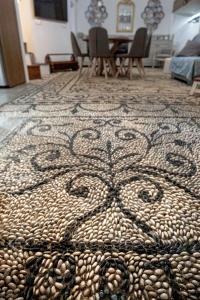 a rug with a snake design on a floor at Antigone Traditional House in Koskinou