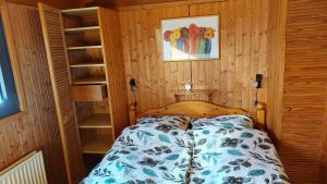 a bedroom with a bed in a wooden room at Lieblingsplatz, Ferienhaus in Schneverdingen