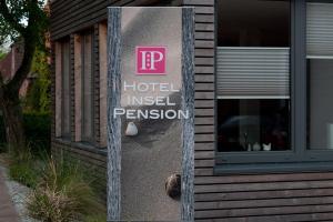 a sign on the side of a hotel invoked permission at Hotel Insel Pension in Niebüll