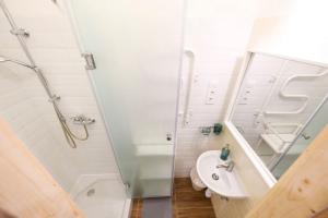 a white bathroom with a shower and a sink at 2 bedroom flat in Nyar str., Boutique in Budapest