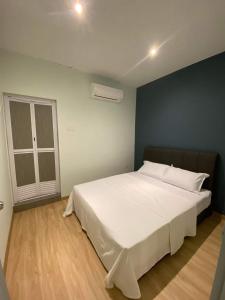 a large white bed in a room with a window at CT HOME83Stay - Klebang Beach Melaka in Kelebang Besar