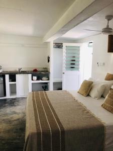a bedroom with a bed and a desk in it at Banana Bay Beach Club in Port Vila