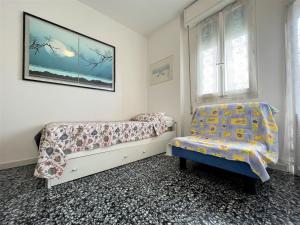 リド・ディ・ポンポーザにあるATTICO Sunshineのベッドルーム1室(ベッド1台、椅子付)